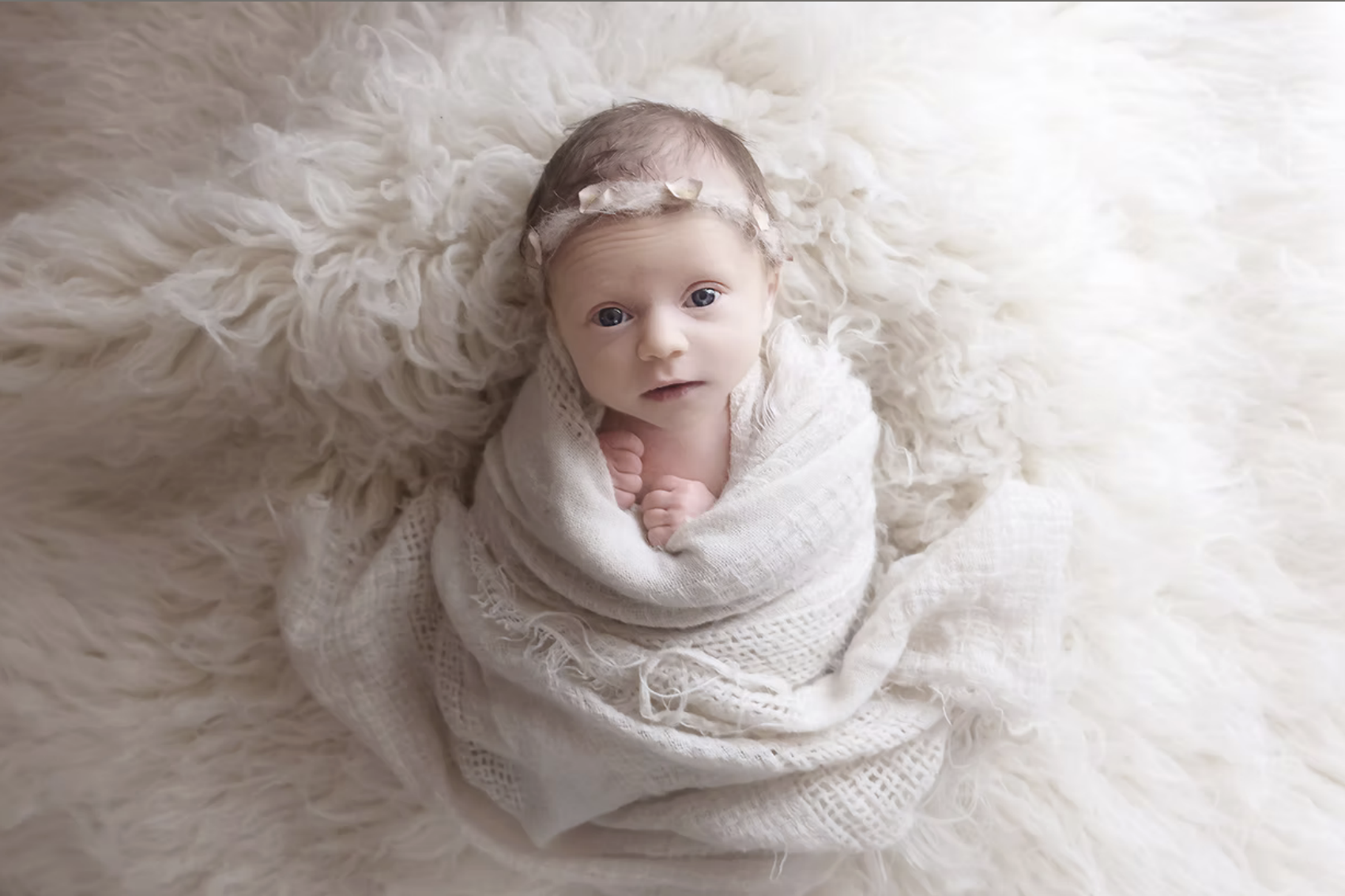 Natural light photographer in Uckfield captured newborn baby swaddled with eyes open
