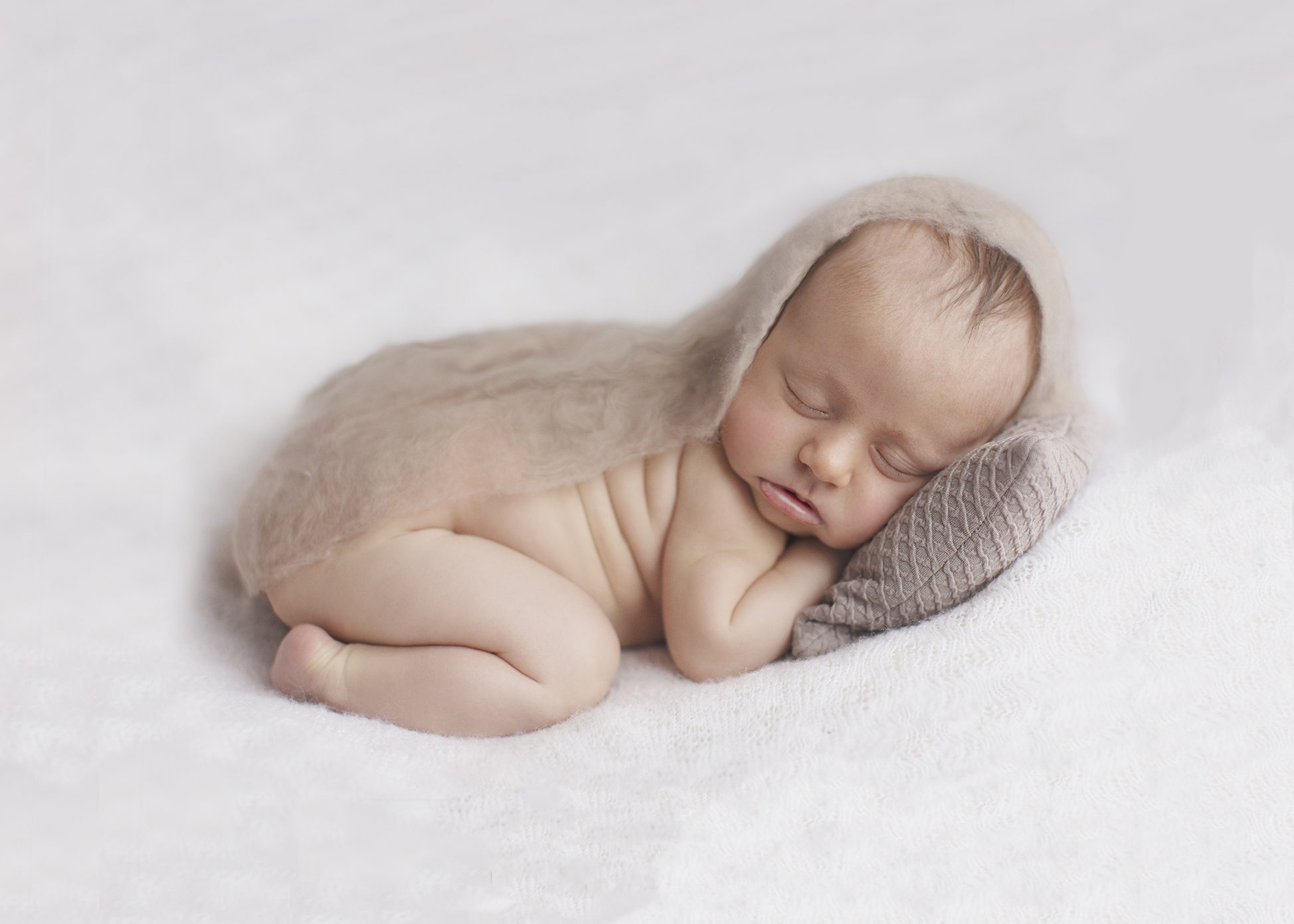 Newborn baby on beanbag sleeping in natural light studio Uckfield
